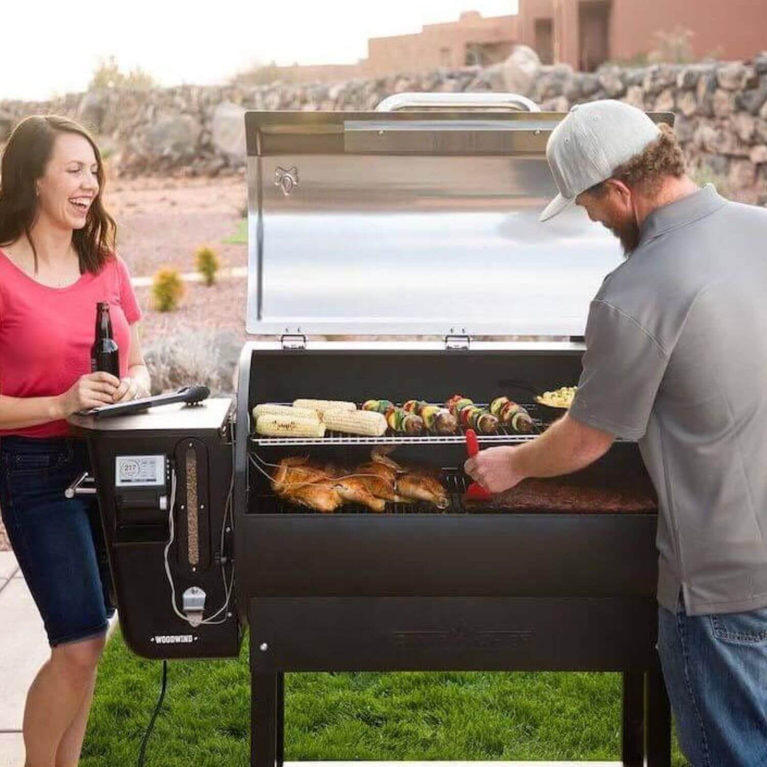 An image of two people cooking on a BBQ outside